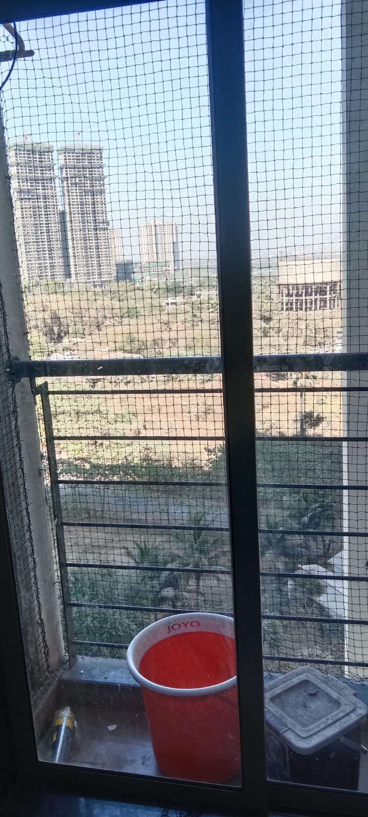 Black balcony bird netting with urban high-rise view